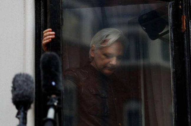 WikiLeaks founder Julian Assange is seen on the balcony of the Ecuadorian Embassy in London